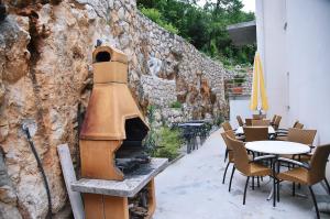 莫什奇尼策Haus Zora Ferienwohnung 7的户外庭院设有壁炉和桌椅。
