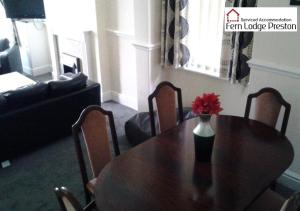 普雷斯顿4 Bedroom House at Fern Lodge Preston Serviced Accommodation - Free WiFi & Parking的一张餐桌,上面有花瓶