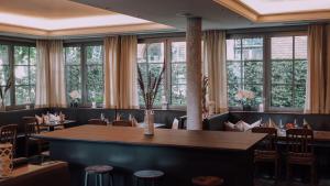 梅明根恩格尔凯勒餐厅酒店的用餐室设有桌椅和窗户。