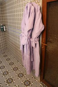 撒马尔罕Hotel Gumbaz的浴室墙上挂着紫色毛巾