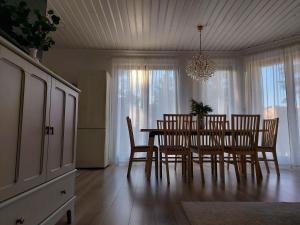 卢克钦Maritima's Home的一间带桌椅和吊灯的用餐室