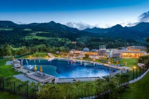 巴特霍夫加施泰因Hotel Das Gastein - ganzjährig inklusive Alpentherme Gastein & Sommersaison inklusive Gasteiner Bergbahnen的度假村设有大型山地游泳池
