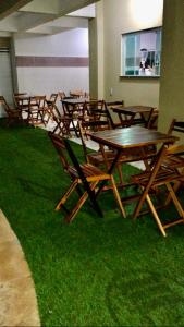 乌巴雅拉Pousada Life的一组木桌和椅子放在草地上