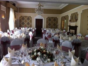哈特尔普尔哈德威克霍尔庄园酒店的大型宴会厅配有白色的桌椅