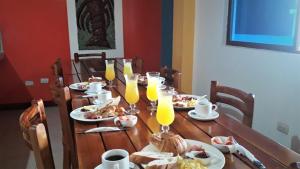 阿约拉港Hostal El Pinzón的一张木桌,上面放有食物和橙汁