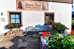 埃尔瓦尔德Haus Tirol Ehrwald的前面有桌子和鲜花的建筑
