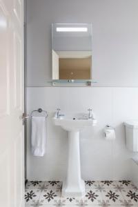 肯梅尔Lagom Restaurant & Townhouse的白色的浴室设有水槽和镜子
