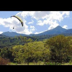 拉夫里尼亚斯Pousada e Restaurante Village Mantovani的风筝飞过天空,飞过一片田野