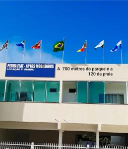 佩尼亚Pousada APART PenhaFlat- Studio a 700 mts do parque的建筑物顶部的一束旗帜