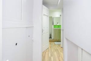 达格纳姆TMS Spacious 4 bedroom house! Free Parking! Crosby Dagenham!的白色的厨房配有白色橱柜和木地板