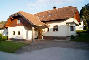 克洛派内尔湖Ferienwohnungen Gerti的白色房子,有棕色的屋顶