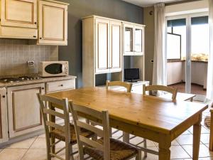 圣温琴佐Apartment Superior-4 by Interhome的厨房配有木桌和椅子