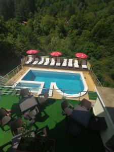 希普科沃Guest House Shipkovo Hills的一个带躺椅和遮阳伞的游泳池