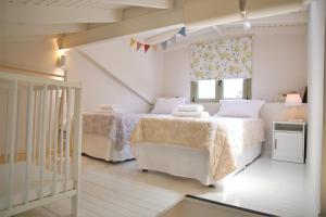 斯巴达For4 Seasons Home 2 - by Avelink的白色的卧室设有床和窗户
