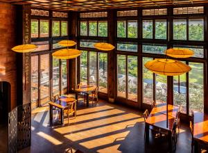 XinpuThe One南园人文客栈的用餐室设有桌椅和窗户。
