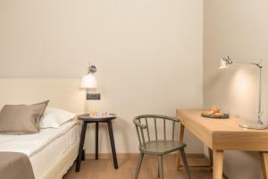萨利MAIORA Luxury Island Suites的配有床、桌子和椅子的房间