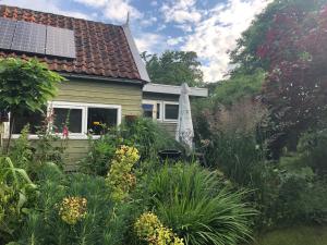 佐伊杜比斯特Beemster Tiny House的房屋前带遮阳伞的花园