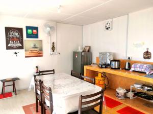 拉瑙D' Limbai Cottage的一间带桌子和冰箱的小厨房