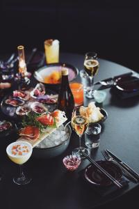 赫尔辛堡Clarion Hotel Sea U的餐桌上放有食物和酒杯的桌子