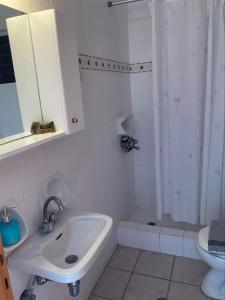 鲁维斯To Perigiali Apartments的白色的浴室设有水槽和卫生间。