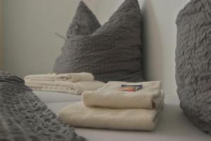 科隆梅林加尼酒店的床上的2条毛巾和2个枕头
