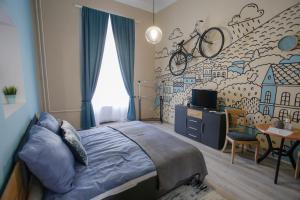 埃格尔Uránia Apartmanház的卧室配有一张床铺,墙上挂有自行车壁画