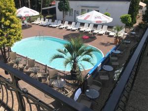 斯蒂格纳Oaza Resort的享有带椅子和遮阳伞的游泳池的上方景色