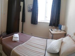 海伦斯堡考迪酒店的一间卧室配有一张床,上面有两条毛巾