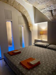 莱切Cuore Barocco的一间带一张床铺的卧室,位于一个拱形的房间