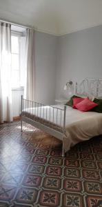 比萨Casa Ridolfi Holiday Home -Una terrazza sui giardini di Pisa的一间卧室设有一张床和一个大窗户