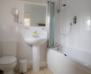 海菲尔德米莉住宿加早餐旅馆的白色的浴室设有水槽、卫生间和浴缸。