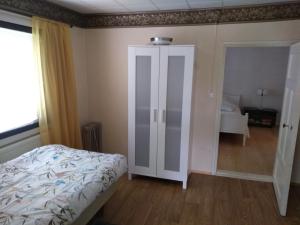 TohkalaOliveira Guesthouse的一间卧室配有一张床和一个带镜子的衣柜