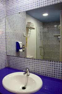 罗萨斯格蕾斯酒店的一间带水槽和镜子的浴室