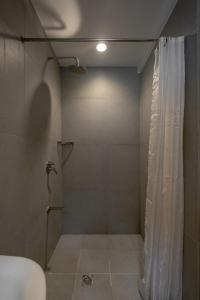 马尼拉iHotel Uptown BGC的带淋浴和浴帘的浴室