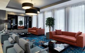 爱丁堡Leonardo Edinburgh Murrayfield的客厅配有两张红色的沙发和一张桌子