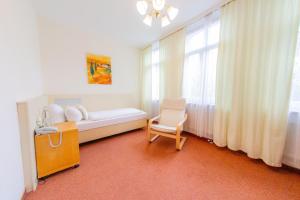 菲尔特Hotel Centro Fürth Nürnberg的卧室配有床、椅子和窗户。