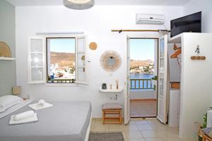 卢特拉NEFELI SUITES KYTHNOS的白色客房 - 带床和阳台