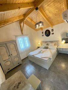 CsisztapusztaIbolya Apartman的一间设有两张床和木制天花板的大卧室
