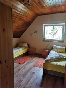 赞考Katica Ház的一间卧室设有两张床和窗户。