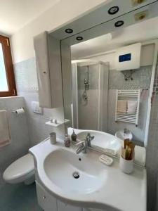普蒂尼亚诺Trullo Bianco的一间带水槽、卫生间和镜子的浴室