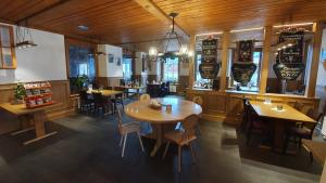 维尔德斯韦尔Gasthof Hirschen in Wilderswil的餐厅铺有木地板,配有桌椅