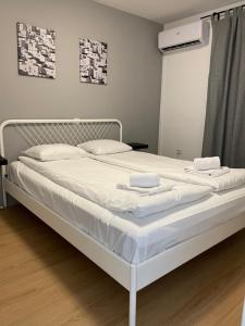波尔托罗Villa Darina的白色的床、白色床单和枕头