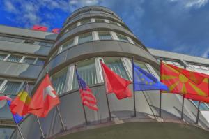 斯科普里Hotel & Resort Bon Bon的建筑物一侧的一组旗帜
