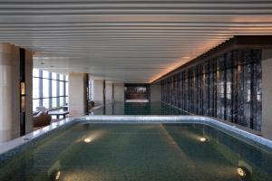 苏州苏州中惠铂尔曼酒店的一座带天花板的建筑中的游泳池