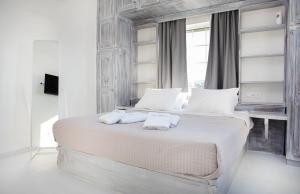 帕罗奇亚Crystal Dreams的白色卧室配有一张带白色枕头的大床
