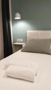 科尔丘拉科尔丘拉菲欧力诺旅馆的一张白色的床,上面有两条白色毛巾