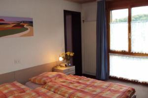 博内夫斯库罗纳餐厅酒店的一间卧室设有两张床和窗户。