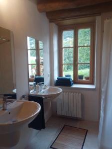 加尔尼亚诺Ca' del Rì的一间带两个盥洗盆和两个窗户的浴室