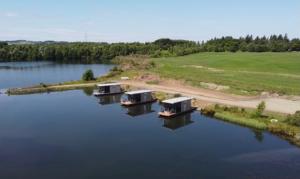 巴斯盖特Couston Lakes Resorts的享有湖泊上三座小屋的空中景致