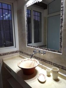拉库布蕾Casa El Descanso的一间带碗水槽和两个窗户的浴室